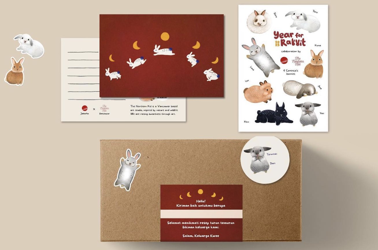 KueKwee Lunar New Year packaging: a kraft cake box with a maroon label and bunny stickers, a red bunny postcard and a Year of the Rabbit sticker sheet